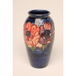 A MOORCROFT POTTERY VASE, mid 20th century, of flared rounded cylindrical form, tubelined and