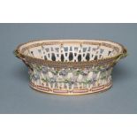 A ROYAL COPENHAGEN PORCELAIN "FLORA DANICA" BASKET of flared oval form with two naturalistic twig