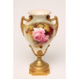 A ROYAL WORCESTER CHINA VASE, 1912, of baluster form with two angular handles, painted in enamels