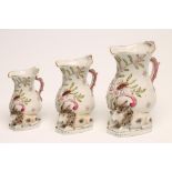 A GRADUATED SET OF THREE CONTINENTAL PORCELAIN "GOAT AND BEE" JUGS, late 19th century, typically