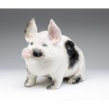 A WEMYSS POTTERY PIG, early 20th century, modelled resting on it's haunches, with black shading to