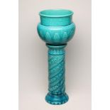 A BURMANTOFTS FAIENCE TURQUOISE GLAZED JARDINIERE AND MATCHED STAND, c.1900, the baluster jardiniere