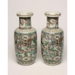 A PAIR OF CHINESE PORCELAIN ROULEAU VASES painted in famille verte enamels with panels enclosing