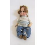 An Armand Marseille bisque head googly eyed doll, with blue glass sleeping eyes, closed mouth, brown