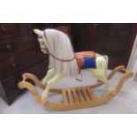 A painted wood rocking horse by Brian Stebbings, 1995, with leather harness on oak bow rockers,