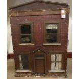 A doll's house, c.1900, painted wood construction with opening front and central door with pediment,