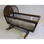 A doll's mahogany finish cradle with arched top, spindled sides and end, on rockers, 32" long, and a