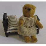 A mid 20th century soldier bear with black/amber eyes, swivel joints, and gold plush covering, and a