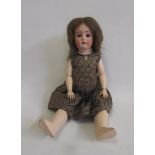 An Alt, Beck & Gottschalck bisque head doll with blue glass sleeping eyes, open mouth and teeth,