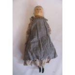 A carved and painted wooden doll, early 19th century, with jointed limbs, original or contemporary