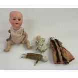 A Theodor Recknagel bisque head doll with blue glass sleeping eyes, open mouth and teeth,