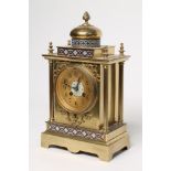 A FRENCH GILT BRASS AND CHAMPLEVE ENAMEL TABLE CLOCK, 20th century, the twin barrel movement