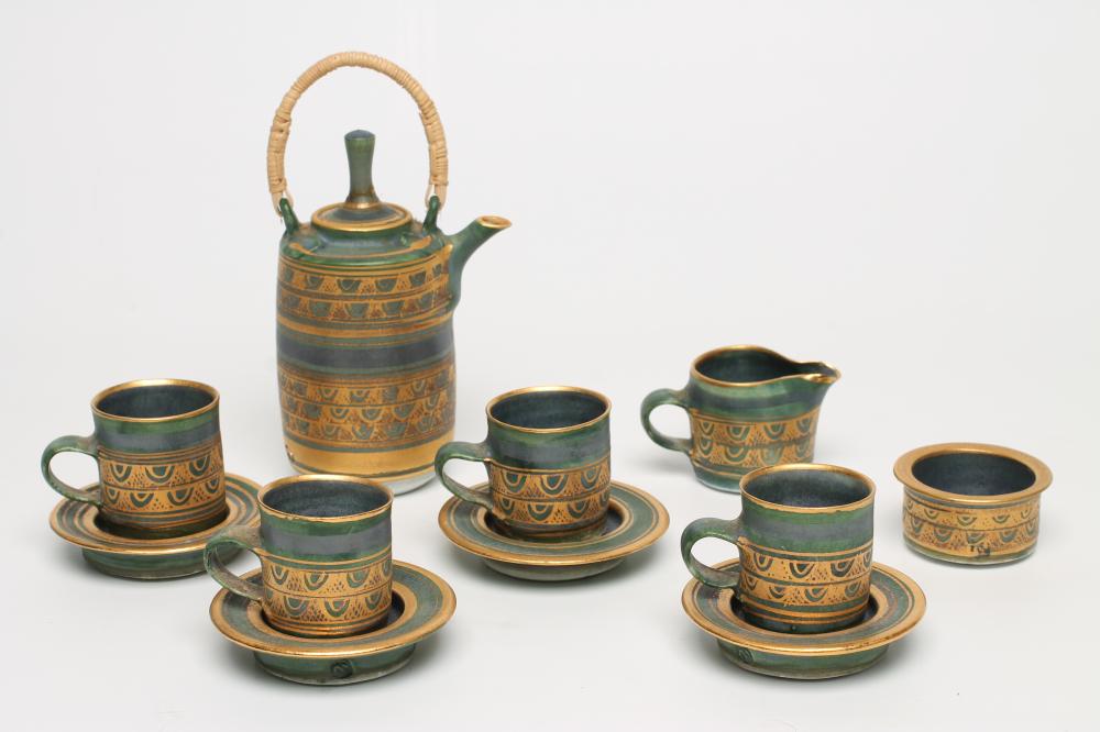 MARY RICH (b.1940), a studio porcelain miniature coffee service with purple/blue and gilt peacock