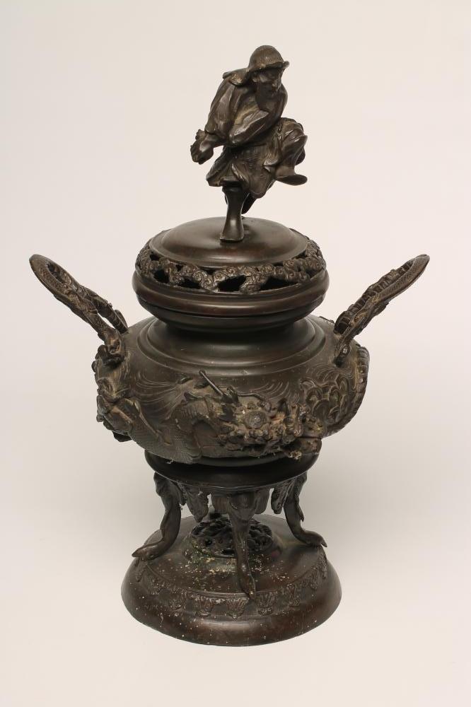 A JAPANESE BRONZE CENSER, the low domed lift-off cover surmounted by a warrior, the squat globular