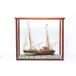 A FOLK ART WOOD MODEL OF A FISHING BOAT, mounted in a glazed case, 26 1/4" wide, 23 1/4" high (