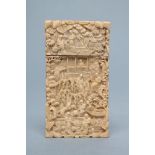 A CANTON IVORY VISITING CARD CASE of plain oblong form, all-over carved with figures at their