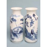 A MATCHED PAIR OF CHINESE PORCELAIN ROULEAU VASES, painted in underglaze blue with vignettes of a