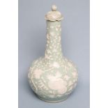 A CHINESE PORCELAIN BOTTLE VASE AND COVER, moulded in relief and incised with flower sprays on a