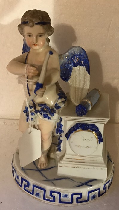 Continental porcelain figure of Cupid - 19cms t. Chip to fingers and wing.