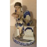 Continental porcelain figure of Cupid - 19cms t. Chip to fingers and wing.