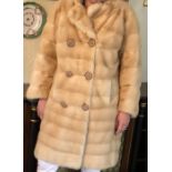 A good quality pale mink three quarter jacket approx size 12.