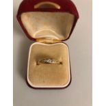 An 18ct carat gold ring set with 5 diamonds, size L/M, 3.9gms.