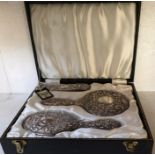 Boxed silver backed mirror, brush and clothes brush.