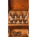 A fitted pine box with chemists bottles.