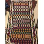 A vintage woven rug, 200 x 102cms.