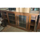 Oak cabinet with sliding doors to front. 87cms h x 178cms w.