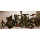 A large quantity of brass and copper items to include jug, kettles, shell cases, ceiling rose etc.