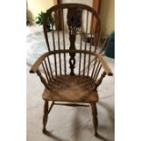 A 19thC Windsor armchair in ash & elm.