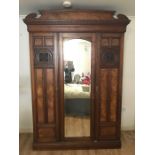 Victorian walnut triple wardrobe with central mirrored door.