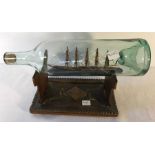 19thC ship in bottle on wooden stand.