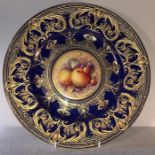 A Royal Worcester fine bone china cobalt blue and gilt overlaid plate, with central hand painted