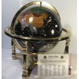 A Lapis Gemstone Globe, 330mm diameter, in a rotating cradle with four sculptured legs and central