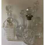 Six various cut-glass decanters including one with silver top and one a.f.