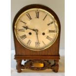 An oak cased mantel clock. 33cms h