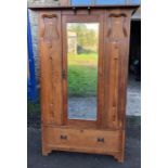 Mirrored door oak wardrobe in the arts and crafts style with drawer to base.