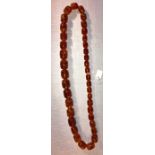 String barrel shaped amber beads. 98.8 gms