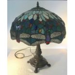 A Large Tiffany style table lamp having bronzed finish, baluster shaped base with a coloured