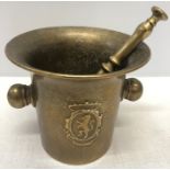 Bronze pestle and mortar with crest to front and rear. 12cms .h