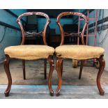 A pair of 19thC balloon backed chairs.