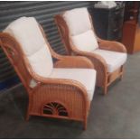 Two rattan chairs and cushions.