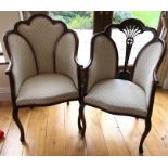 Two mahogany upholstered armchairs.