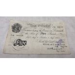 A Bank Of England white £5 note, London 1st August 1945 signed 'K.O. Peppiatt' No. J86 006128.