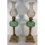 Pair of brass and glass oil lamps, 54cms h. 20 M.C. good condition.