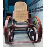 Rocking chair with caned back and seat.