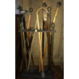 19thC cast iron stick stand to include a large quantity of walking sticks.