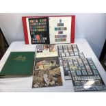Two albums of British and world stamps and six packs of British mint stamps collectors packs, 87,